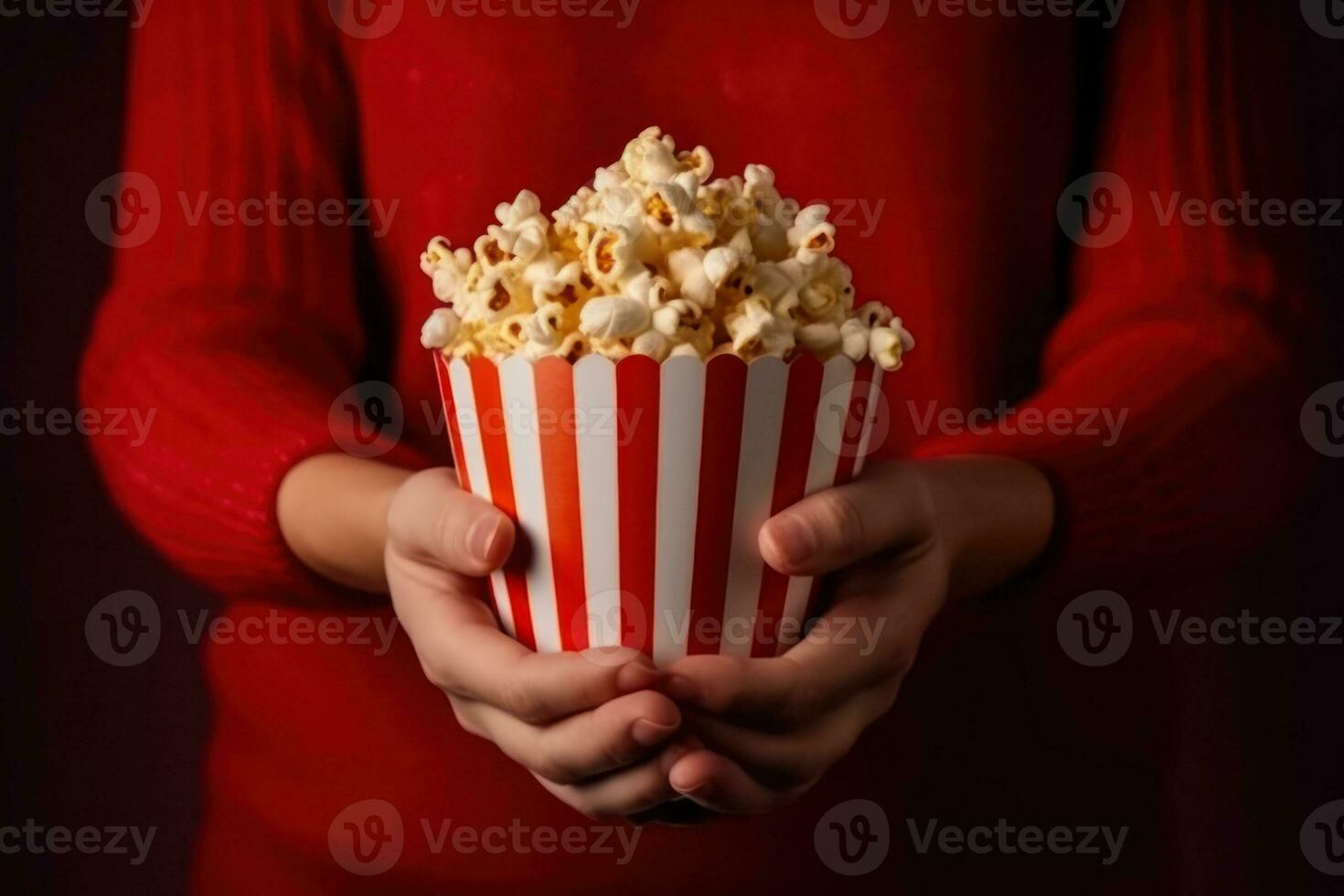 Close up on a red and white striped popcorn cup in a movie theater. Generative AI photo