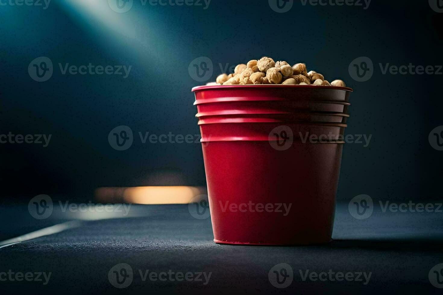 a red cup filled with popcorn on a dark table. AI-Generated photo