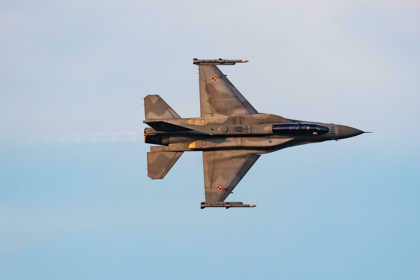 Polish Air Force Lockheed F-16 Fighting Falcon fighter jet plane flying. Aviation and military aircraft. photo
