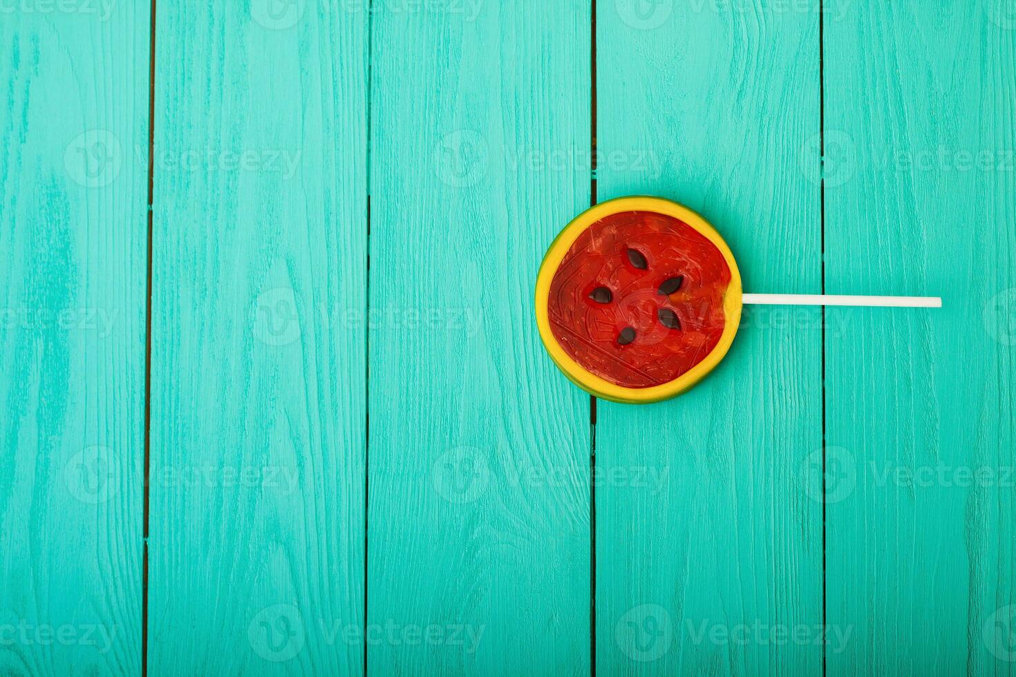 Watermelon summer candy food on blue wooden background. Top view. Mock up. Copy space. Sweet Lollipop photo