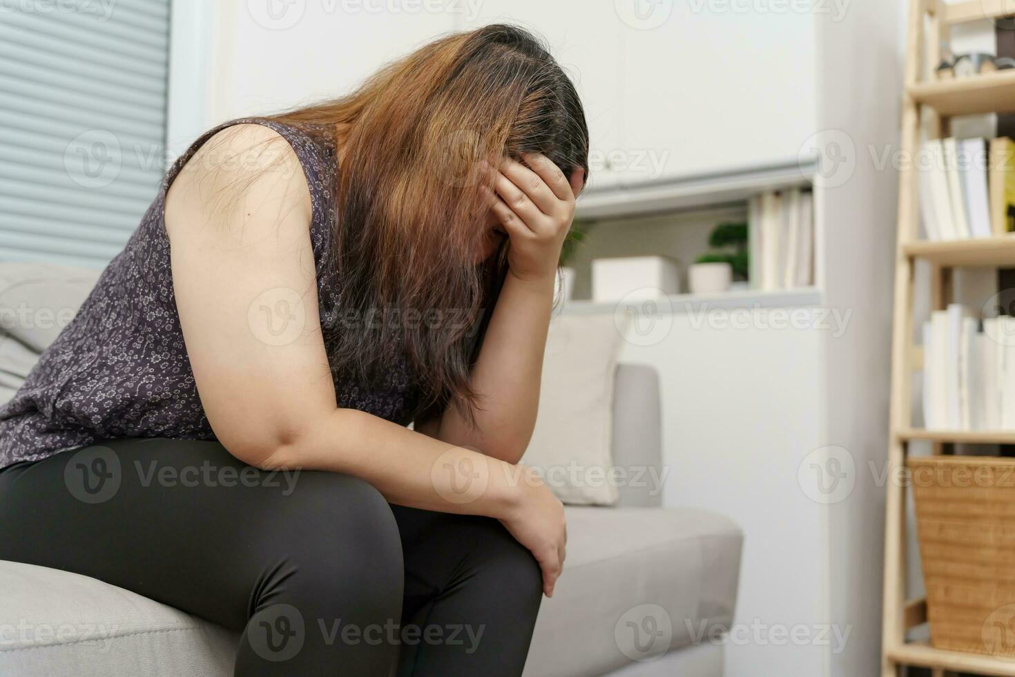 Sad Overweight plus size woman thinking about problems on sofa upset girl feeling lonely and sad from bad relationship or Depressed woman disorder mental health photo