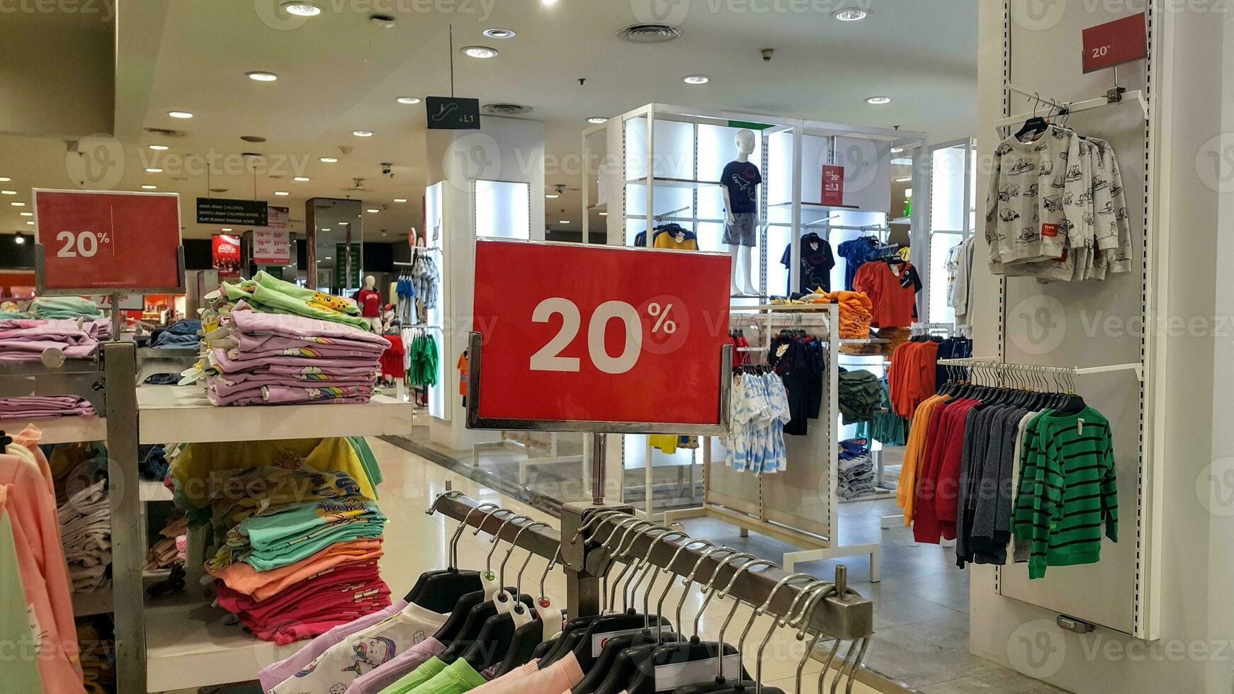 Clothing store with 20 percent red discount banners. Discount, promotions, sales in shopping centers and shops. photo