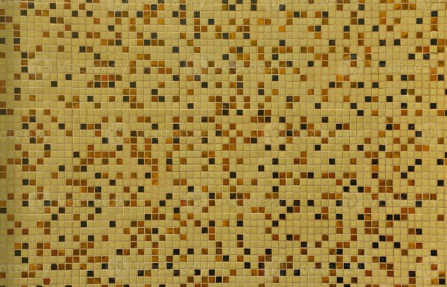 The texture of the wall, decorated with a mosaic of various small square tiles. Abstract pattern of ceramic tiles on the wall photo