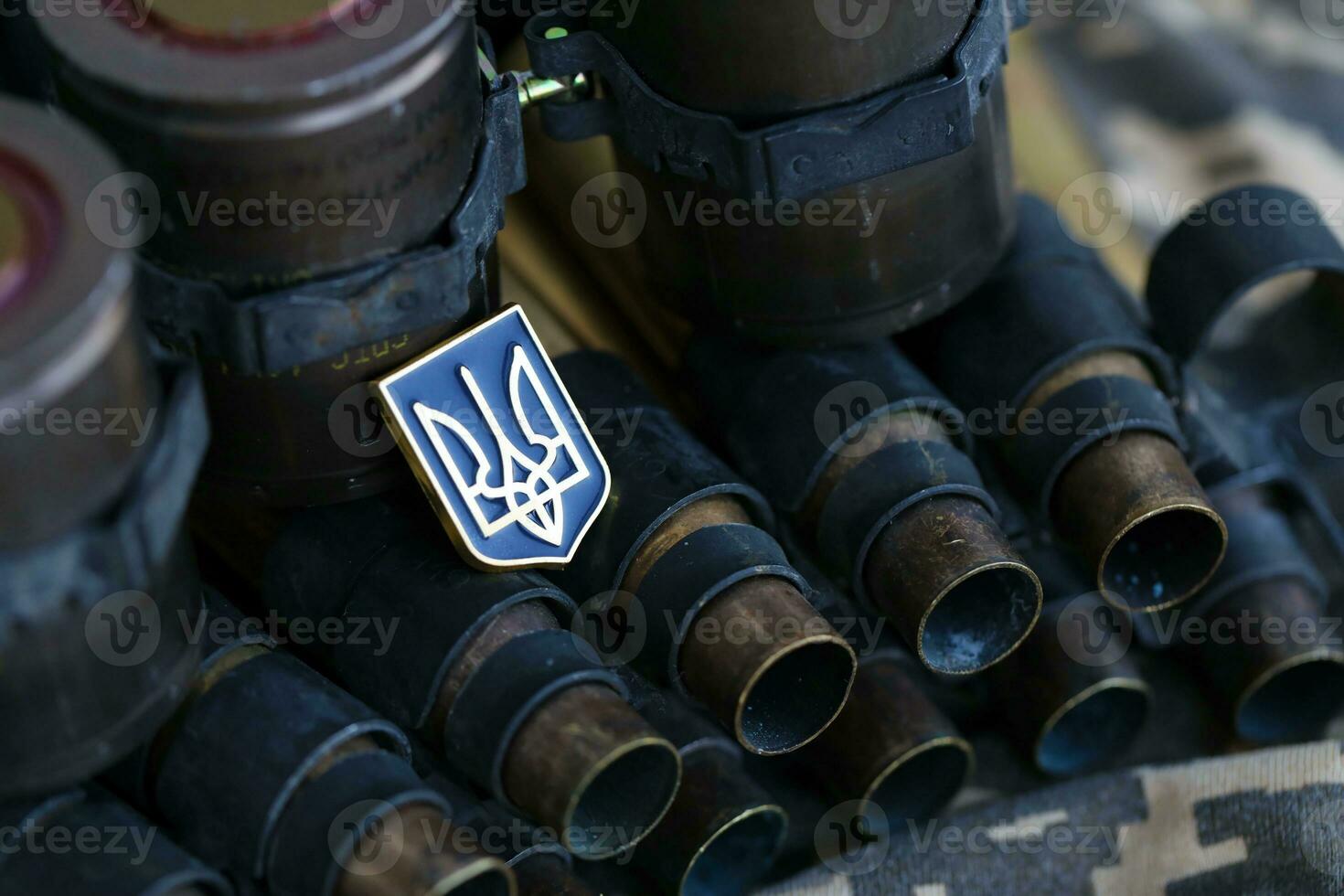 Ukrainian symbol on machine gun belt lies on ukrainian pixeled military camouflage photo