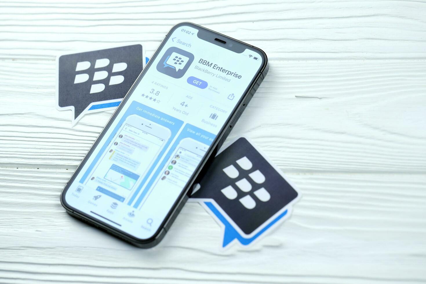 KHARKOV, UKRAINE - MARCH 5, 2021 Blackberry messenger icon and application from App store on iPhone 12 pro display screen on white table photo