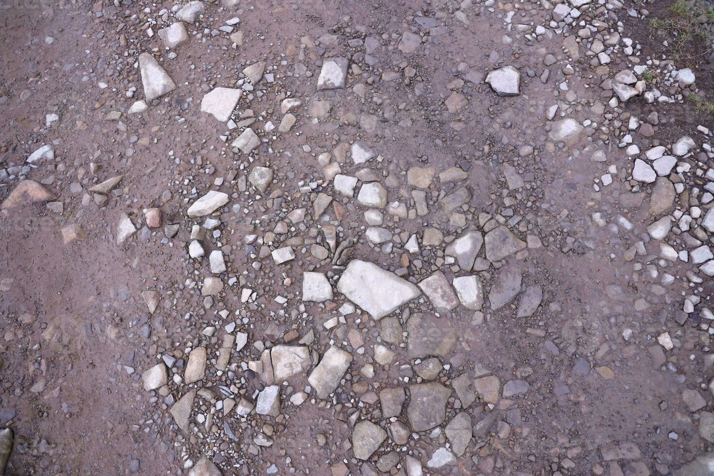 Background of shattered stony stones surface in mountain area. Texture with natural light photo