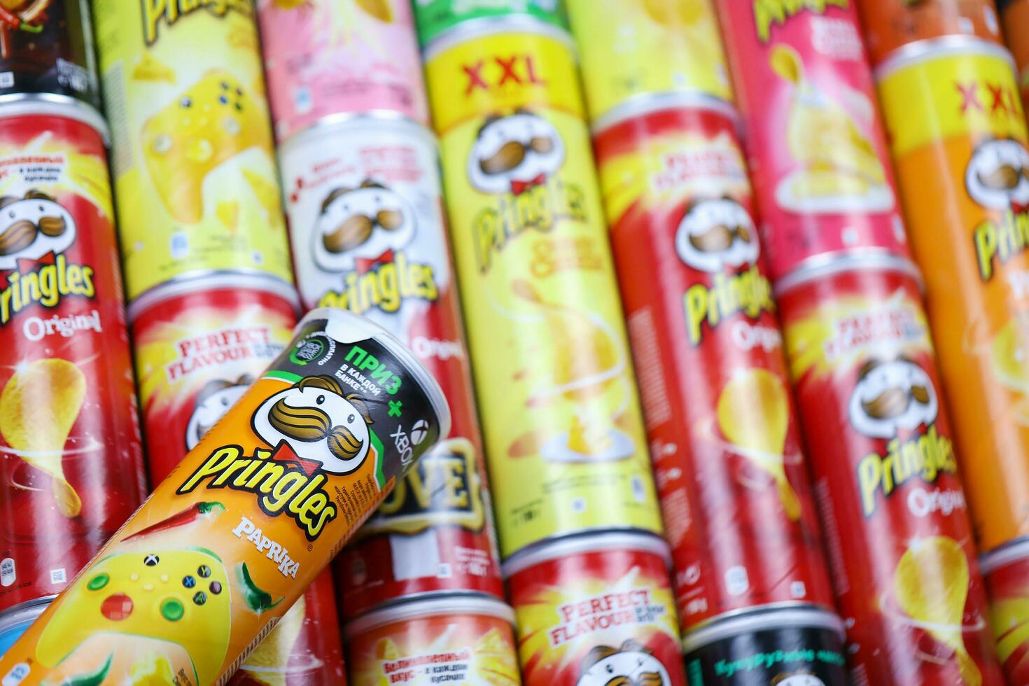 KHARKOV, UKRAINE - MARCH 30, 2021 Many Pringles cylinder chips boxes with varios colors and flavours. American brand of stackable potato-based crisps photo