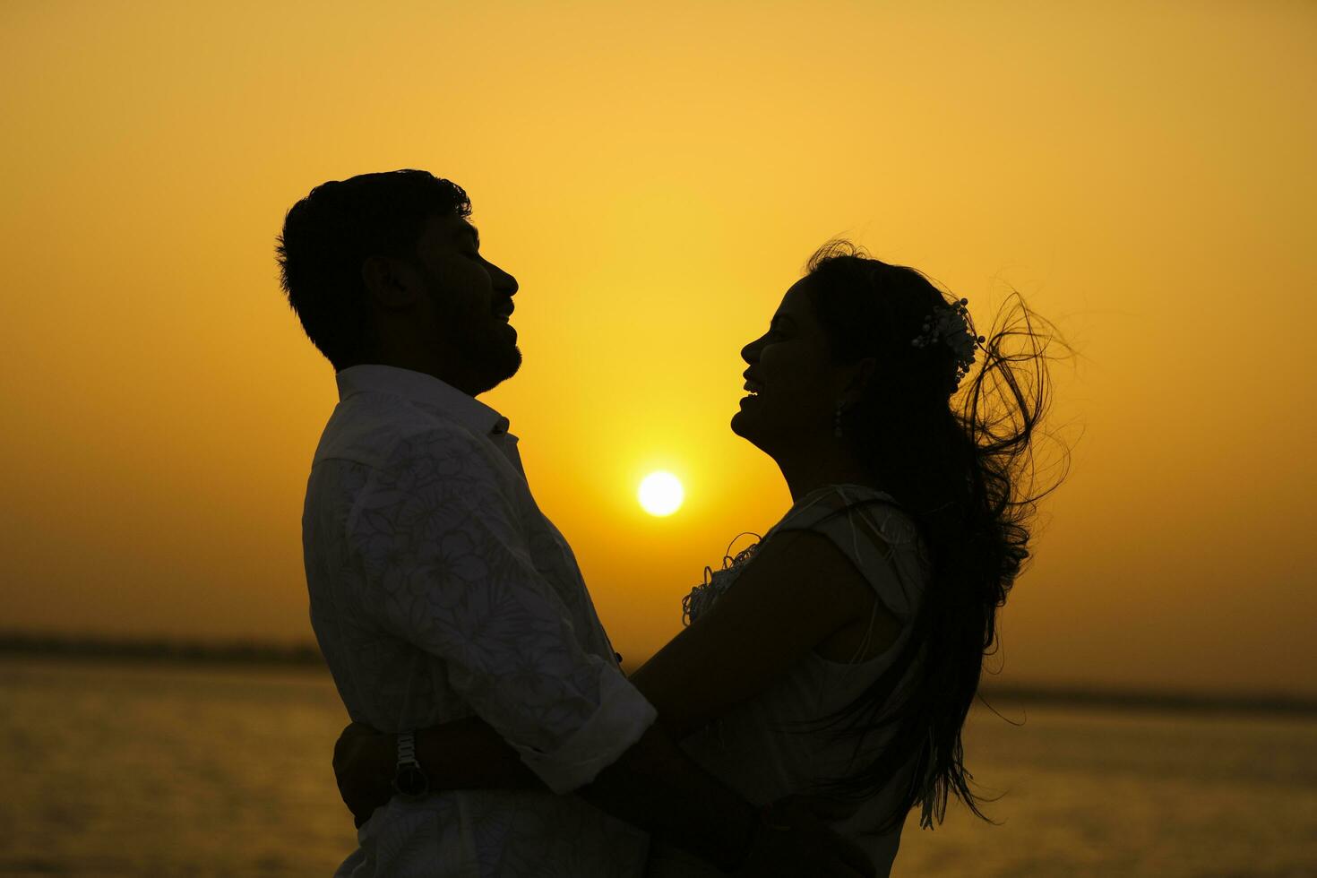 Couple on the beach at sunset silhouettes-Romantic summer photo