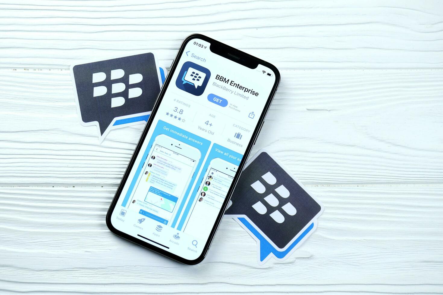 KHARKOV, UKRAINE - MARCH 5, 2021 Blackberry messenger icon and application from App store on iPhone 12 pro display screen on white table photo