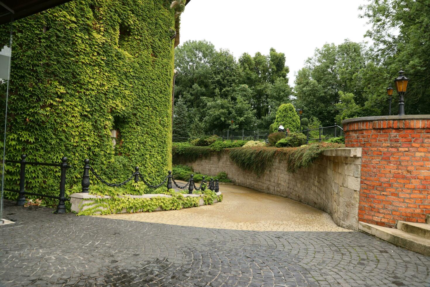 LVIV, UKRAINE - SEPTEMBER 11, 2022 A picturesque landscaped garden at the citadel in Lviv. Fortification defensive brick building of the Middle Ages photo