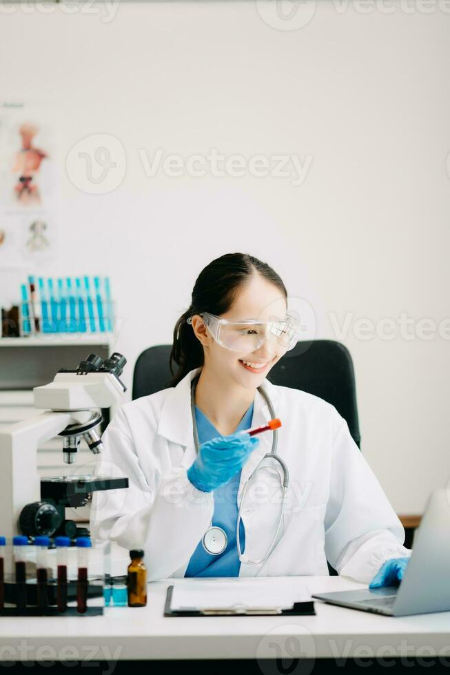 Female scientist researcher conducting an experiment working in chemical laboratory photo