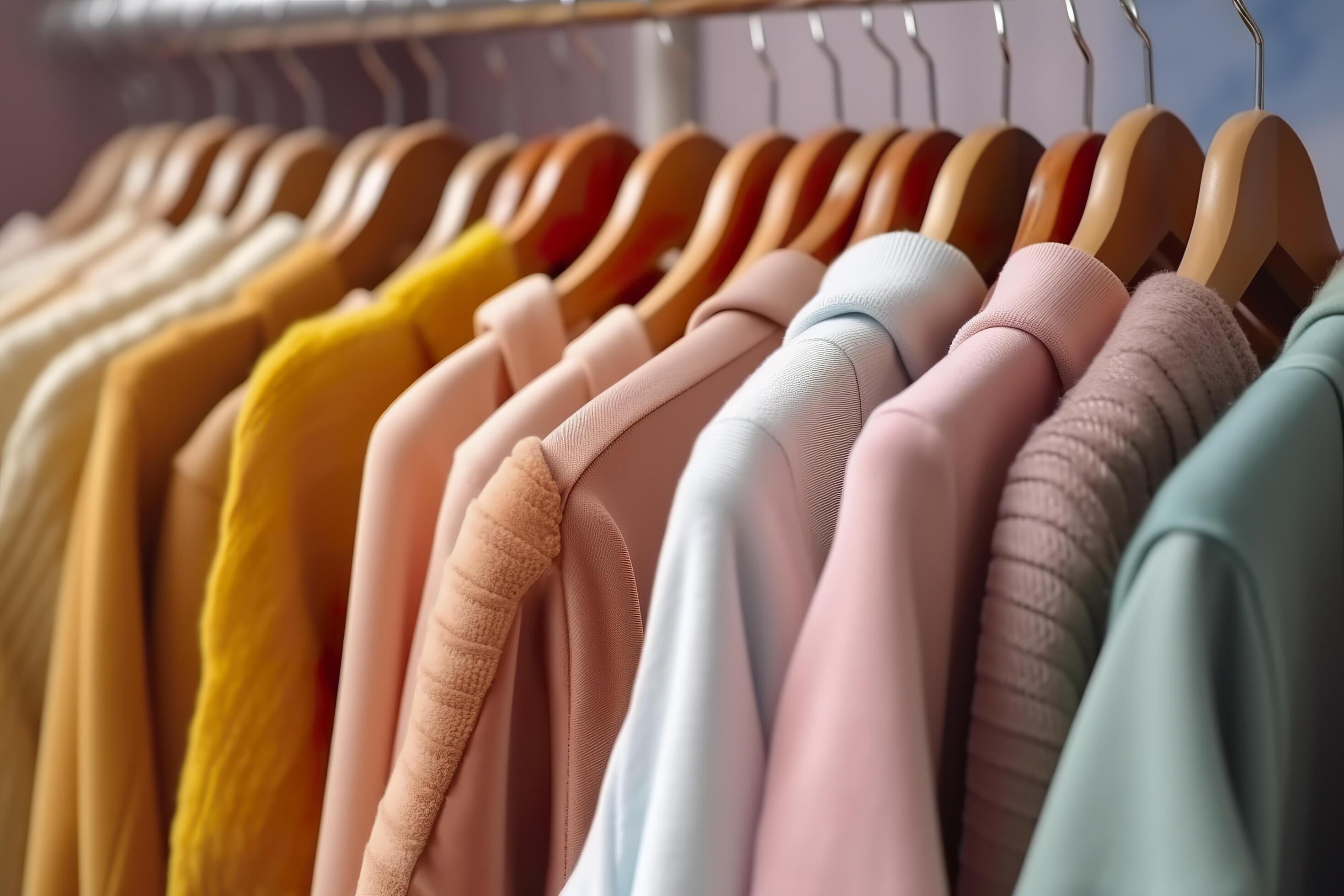 Colorful clothes on a clothing rack, pastel colorful closet in a