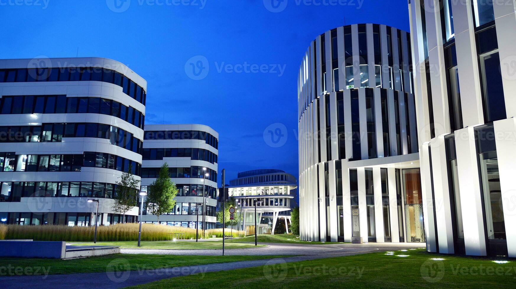 Pattern of office buildings windows illuminated at night. Glass architecture ,corporate building at night - business concept. photo