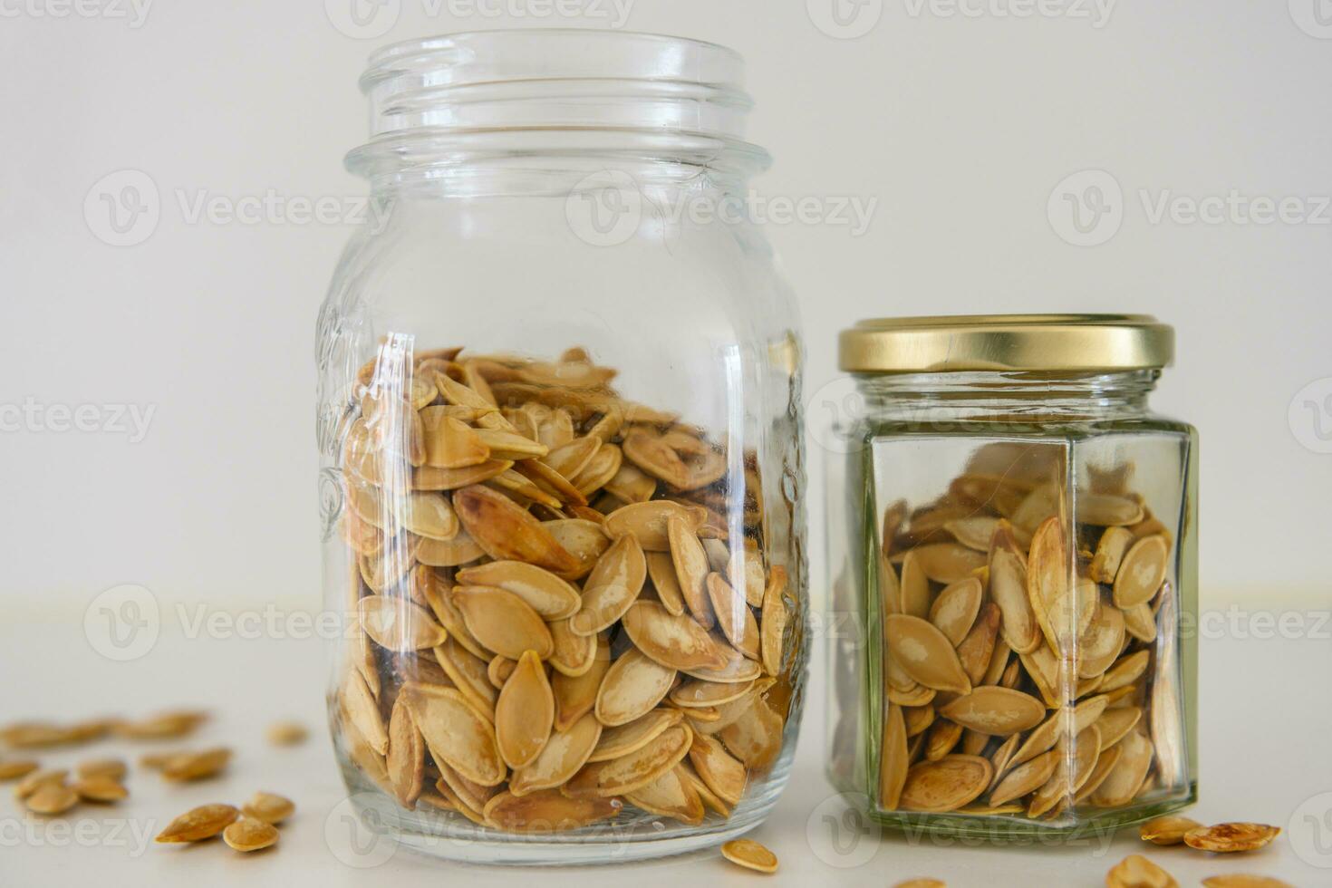 Two jars with pepitas on a kitchen table photo
