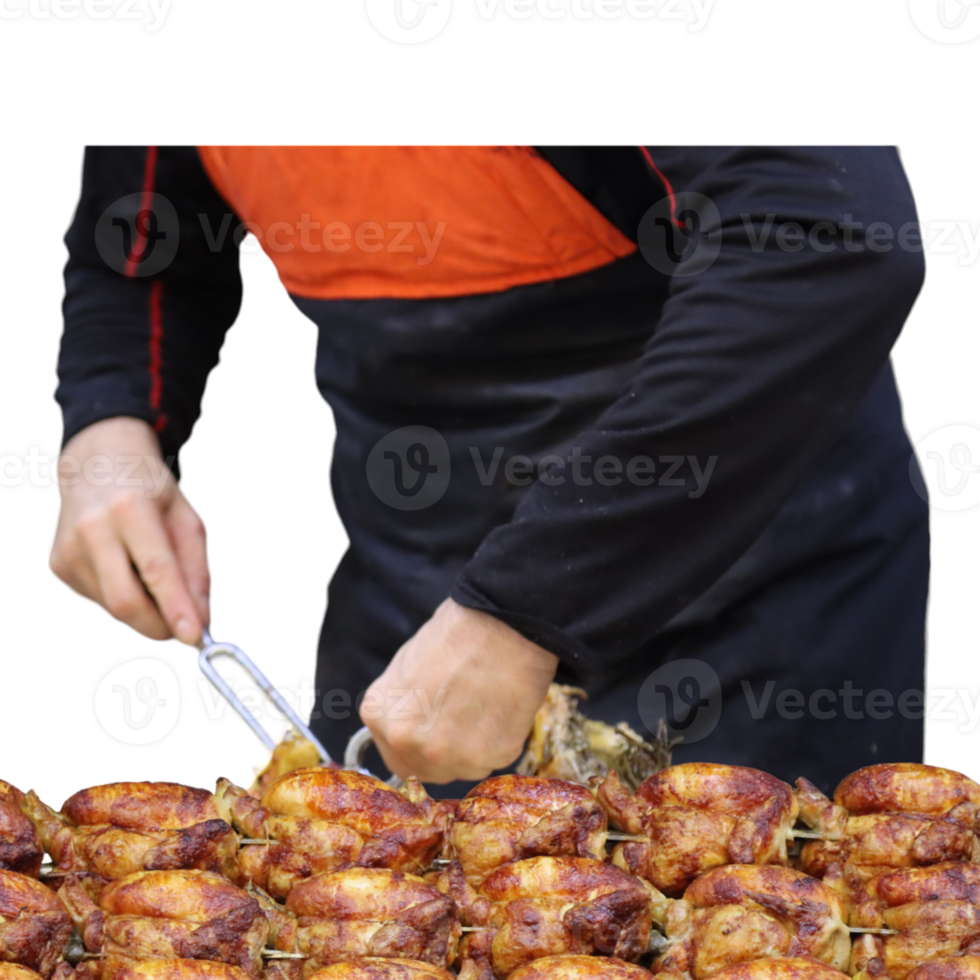 Hawkish rotisserie attendant cuts and serves grilled chicken- png