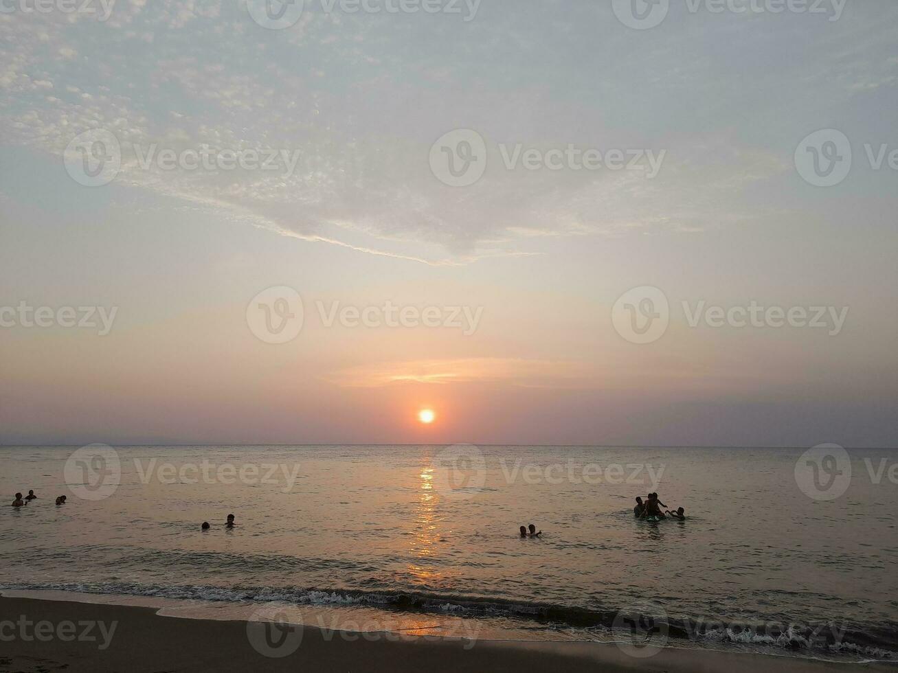 Nature background. Sky, sun and clouds with rays of light at sunset on the island of Lombok, Indonesia. photo