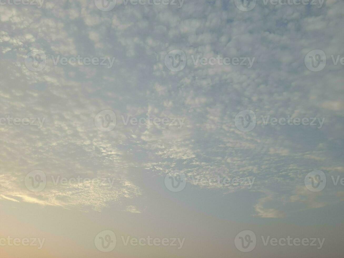 Nature background. Sky, sun and clouds with rays of light at sunset on the island of Lombok, Indonesia. photo