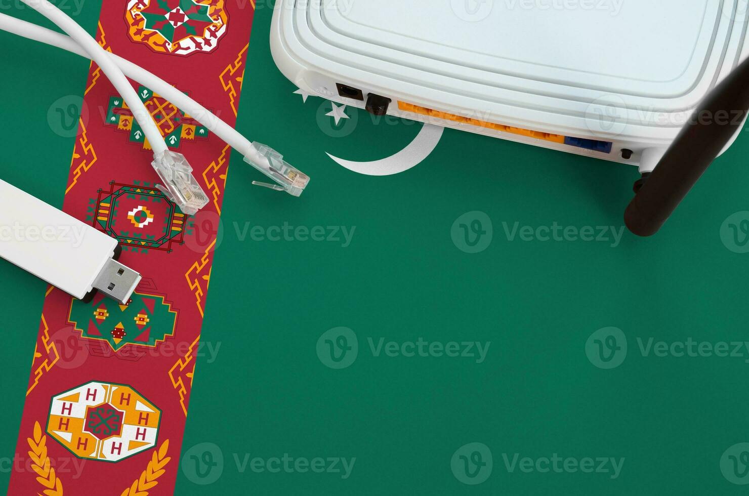 Turkmenistan flag depicted on table with internet rj45 cable, wireless usb wifi adapter and router. Internet connection concept photo