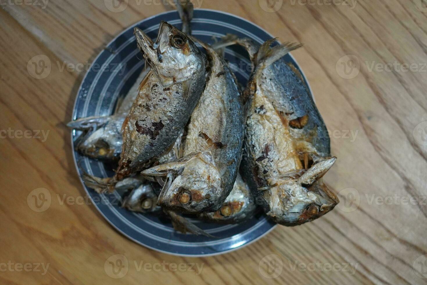 top view Several fried mackerel Stacked on a ceramic plate. Place on the table background, fish, food, object, health, copy space photo