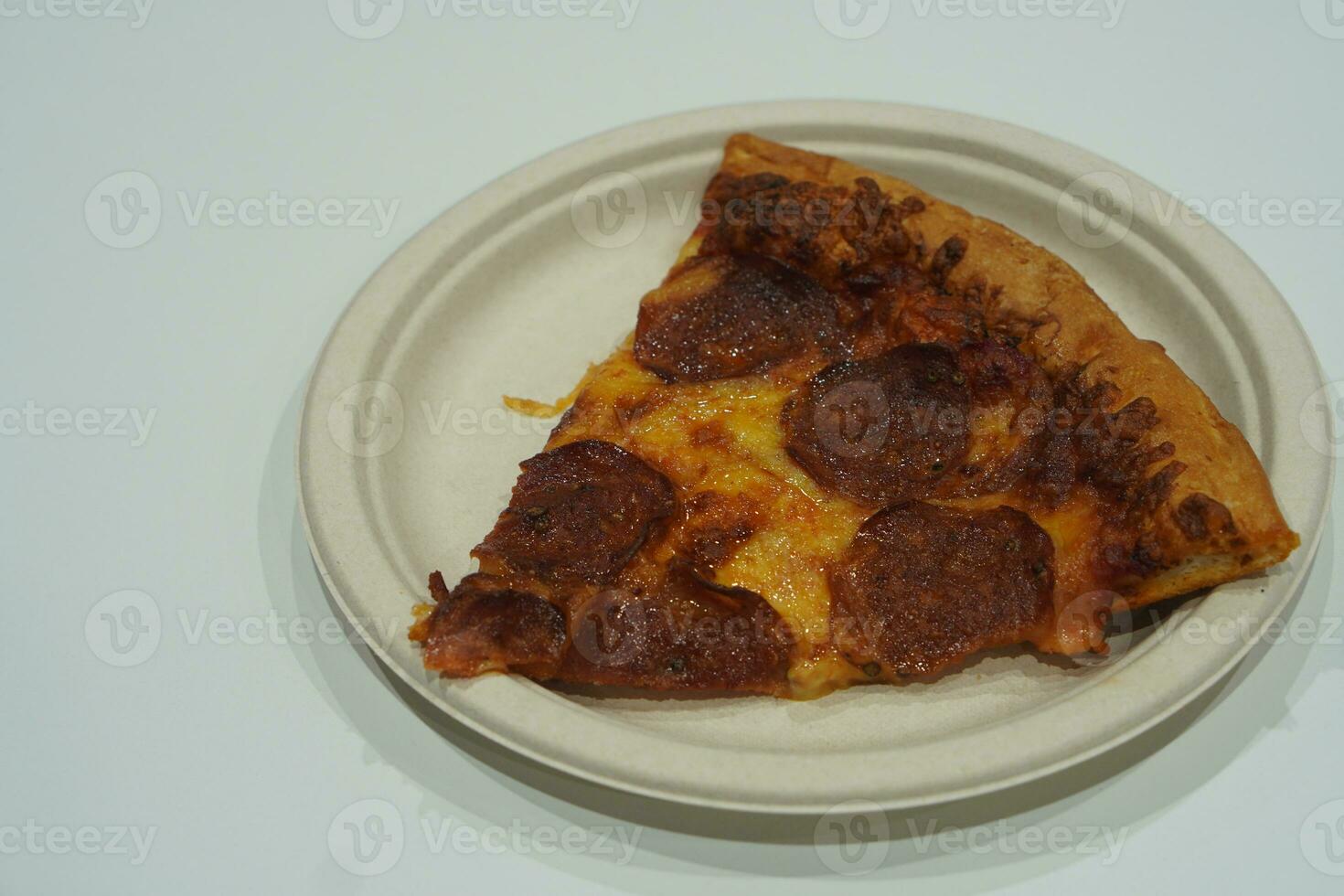 hot pizza with bacon and pork on a paper plate on white floor background, food, italy food, health, copy space photo