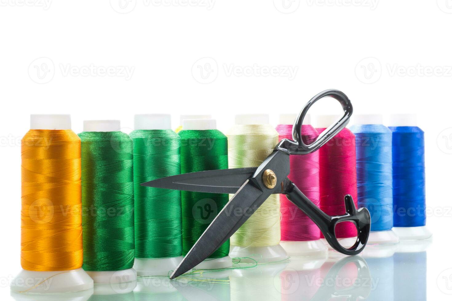 set of different color sewing threads,on white background. photo