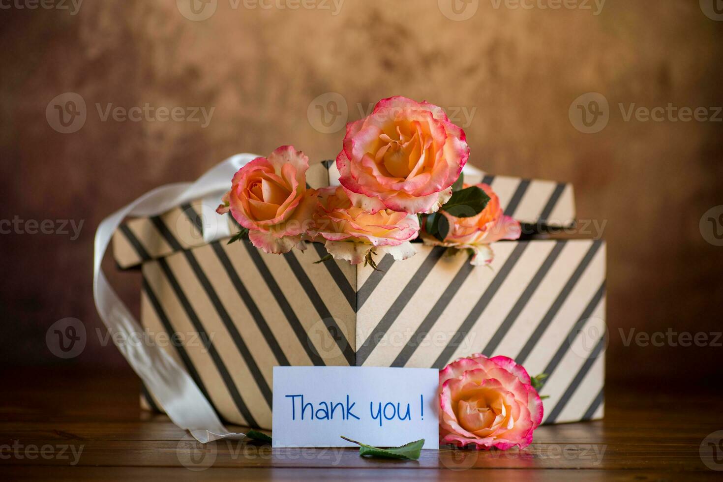 gift box with ribbons and beautiful roses inside. photo