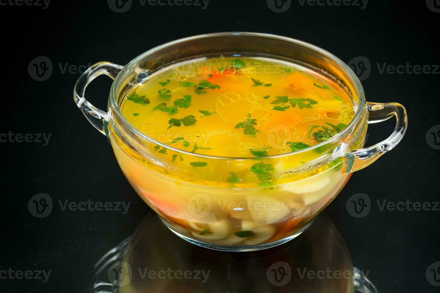 cooked vegetarian mushroom soup with vegetables and pasta in a plate photo