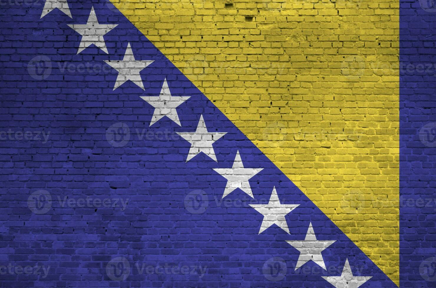 Bosnia and Herzegovina flag depicted in paint colors on old brick wall. Textured banner on big brick wall masonry background photo
