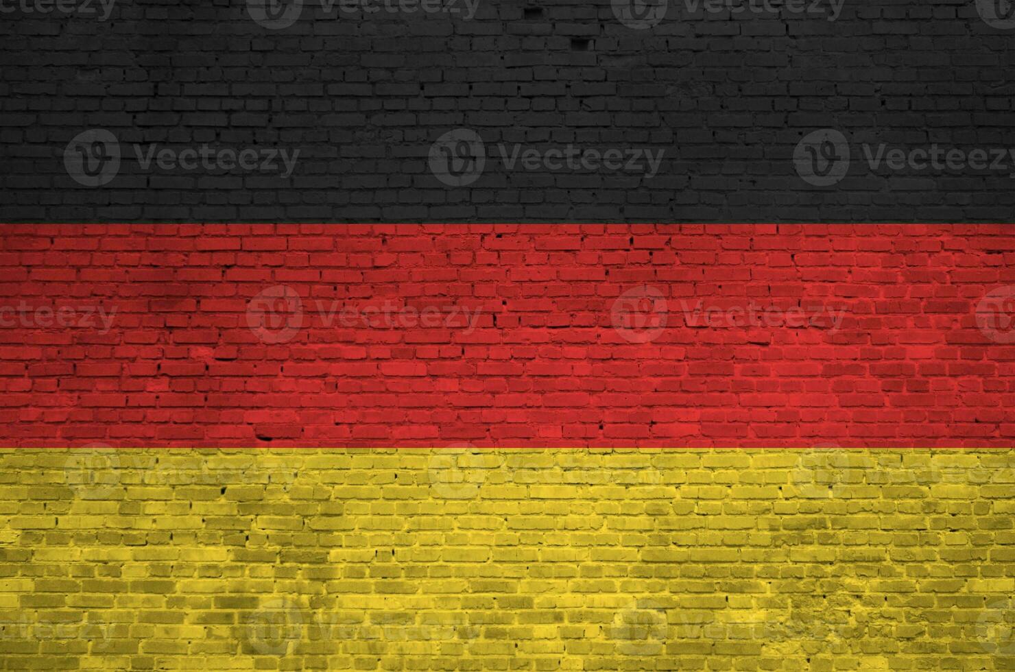 Germany flag depicted in paint colors on old brick wall. Textured banner on big brick wall masonry background photo