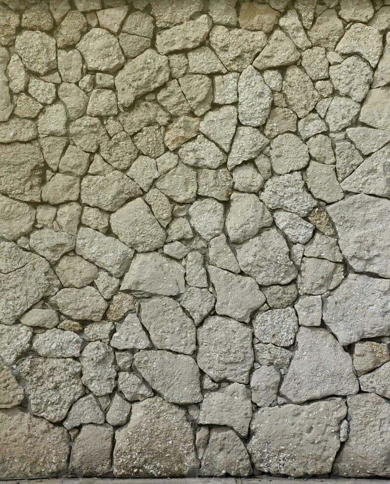 Very old brick stone wall of castle or fortress of 18th century. Full frame wall with obsolete dirty and cracked bricks photo