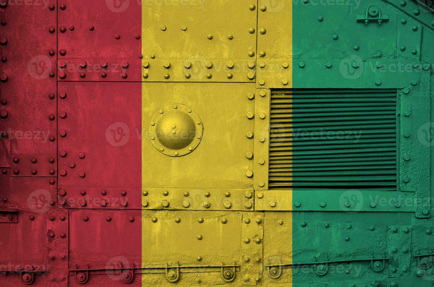 Guinea flag depicted on side part of military armored tank closeup. Army forces conceptual background photo