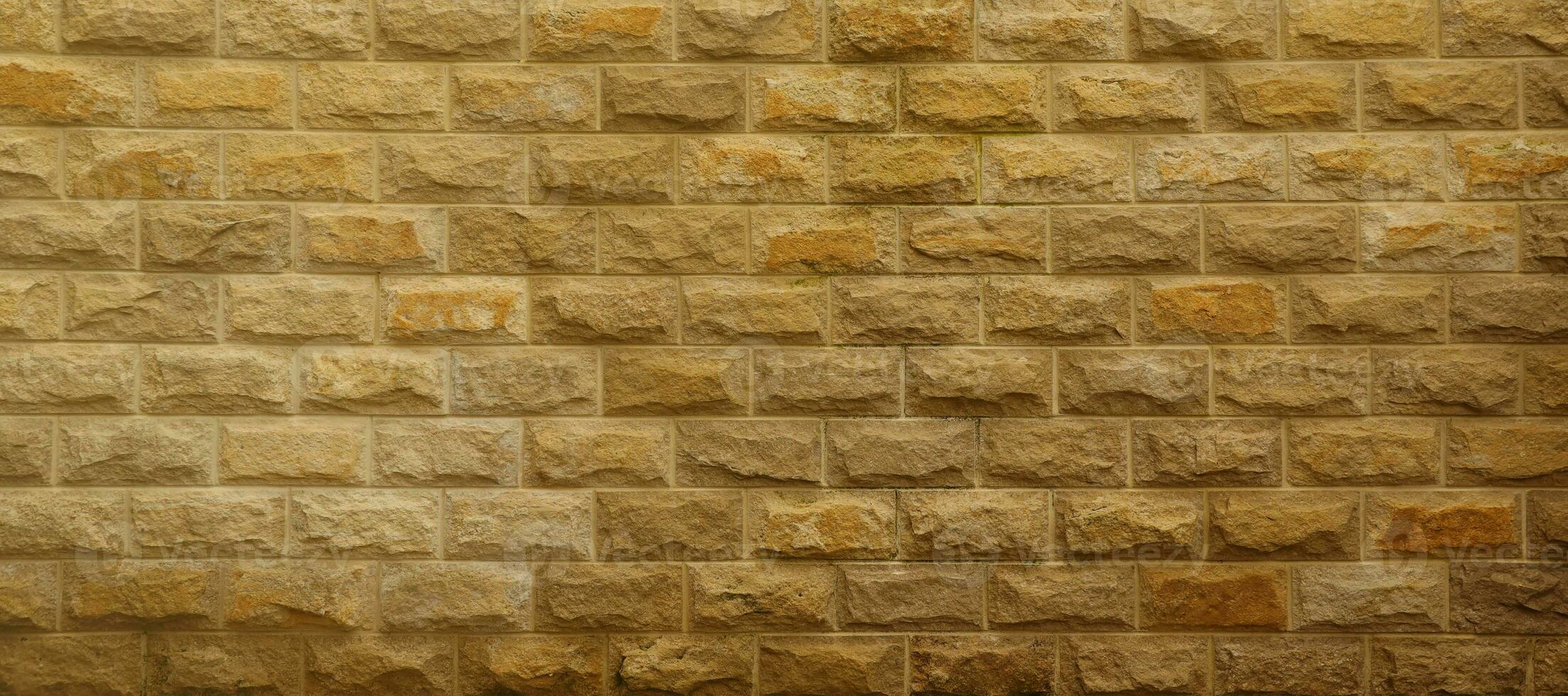 Very old brick stone wall of castle or fortress of 18th century. Full frame wall with obsolete dirty and cracked bricks photo