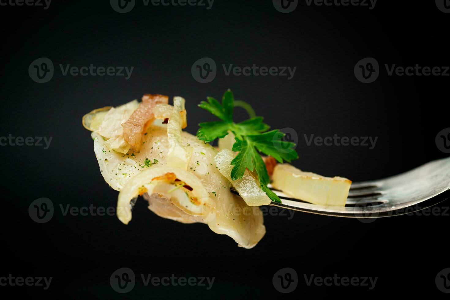 Ukrainian dumplings stuffed with potatoes and mushrooms, served with fried onions. photo