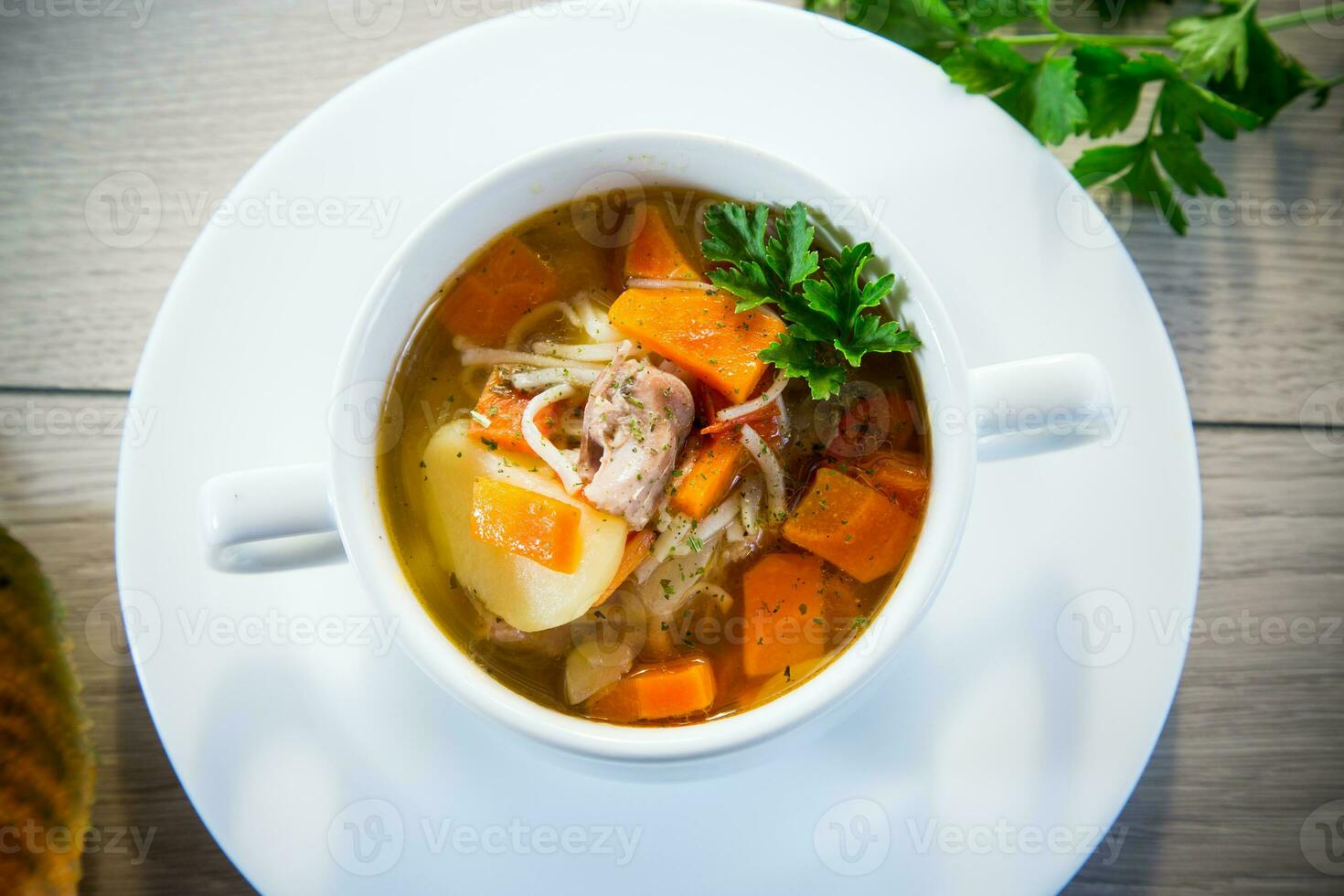 Autumn soup with chicken, noodles and autumn vegetables in a bowl . photo