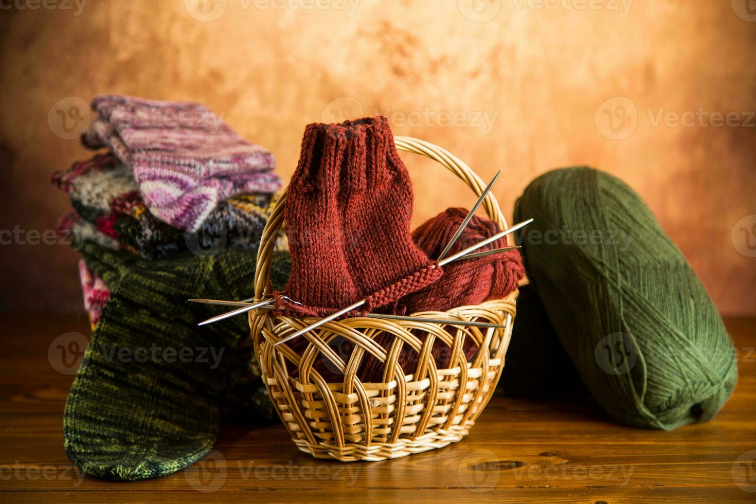 Colored yarn, knitting needles and other items for hand knitting . photo