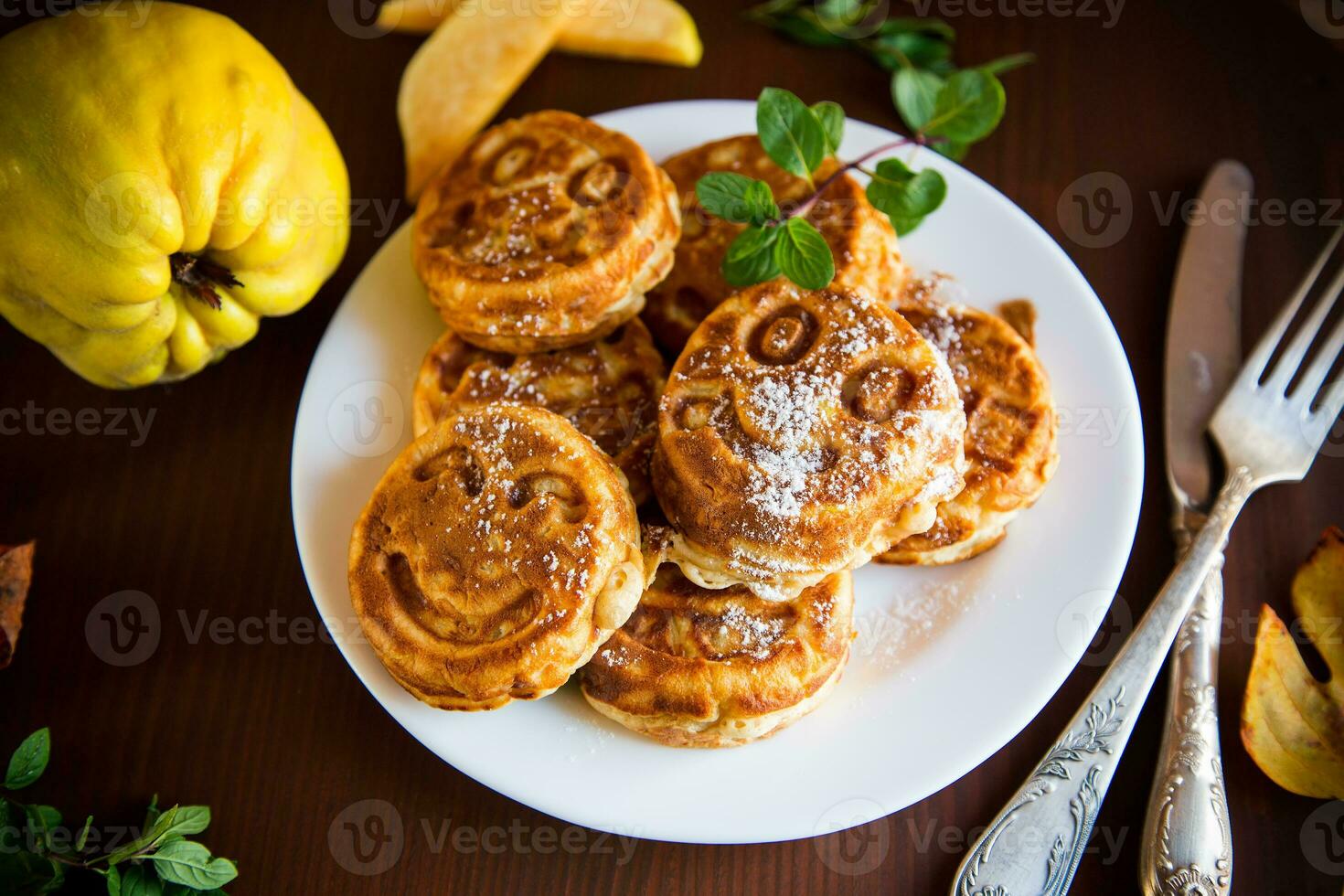 Cooked fried round pancakes with quince filling on a wooden table photo