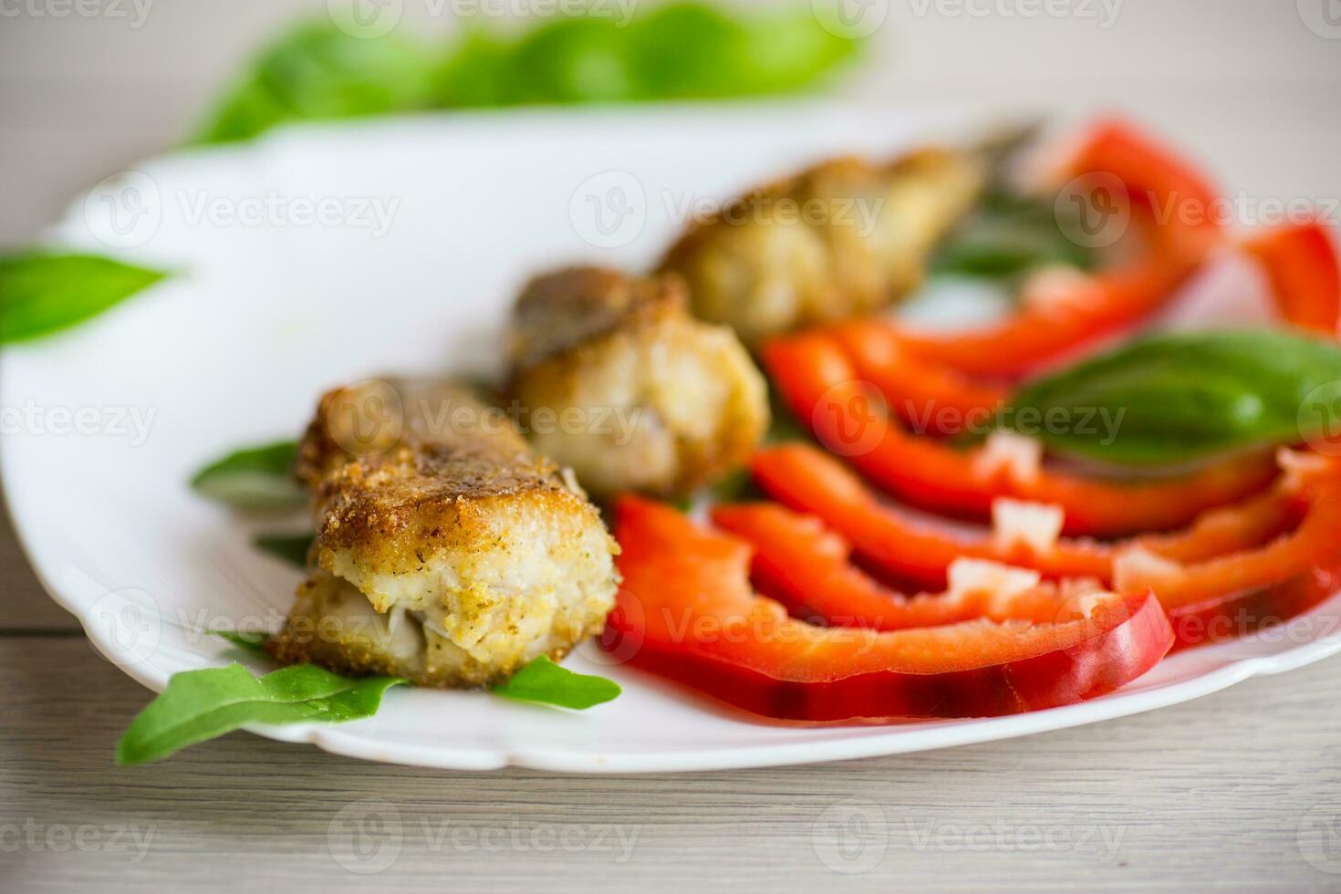 Pieces of fried hake fish in a plate with pepper photo