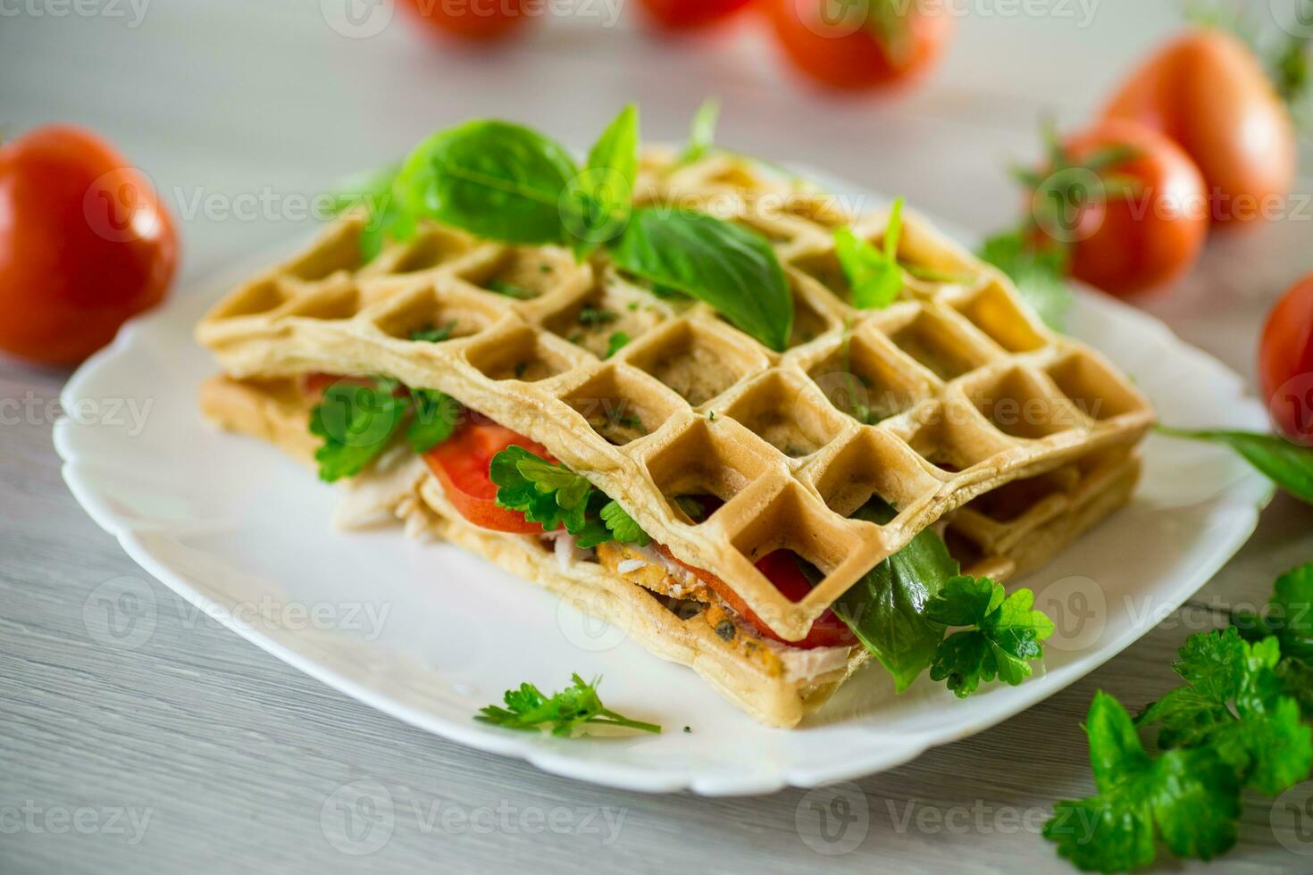 Sandwich of two egg omelettes with bacon and tomatoes inside photo