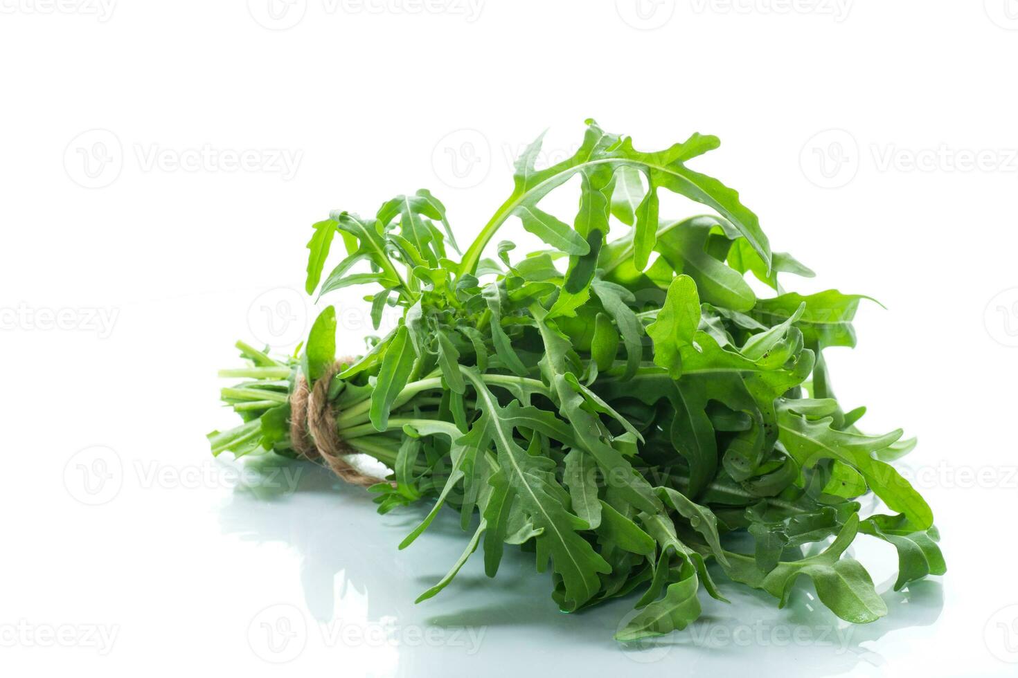 bunch of fresh organic green arugula on white background photo