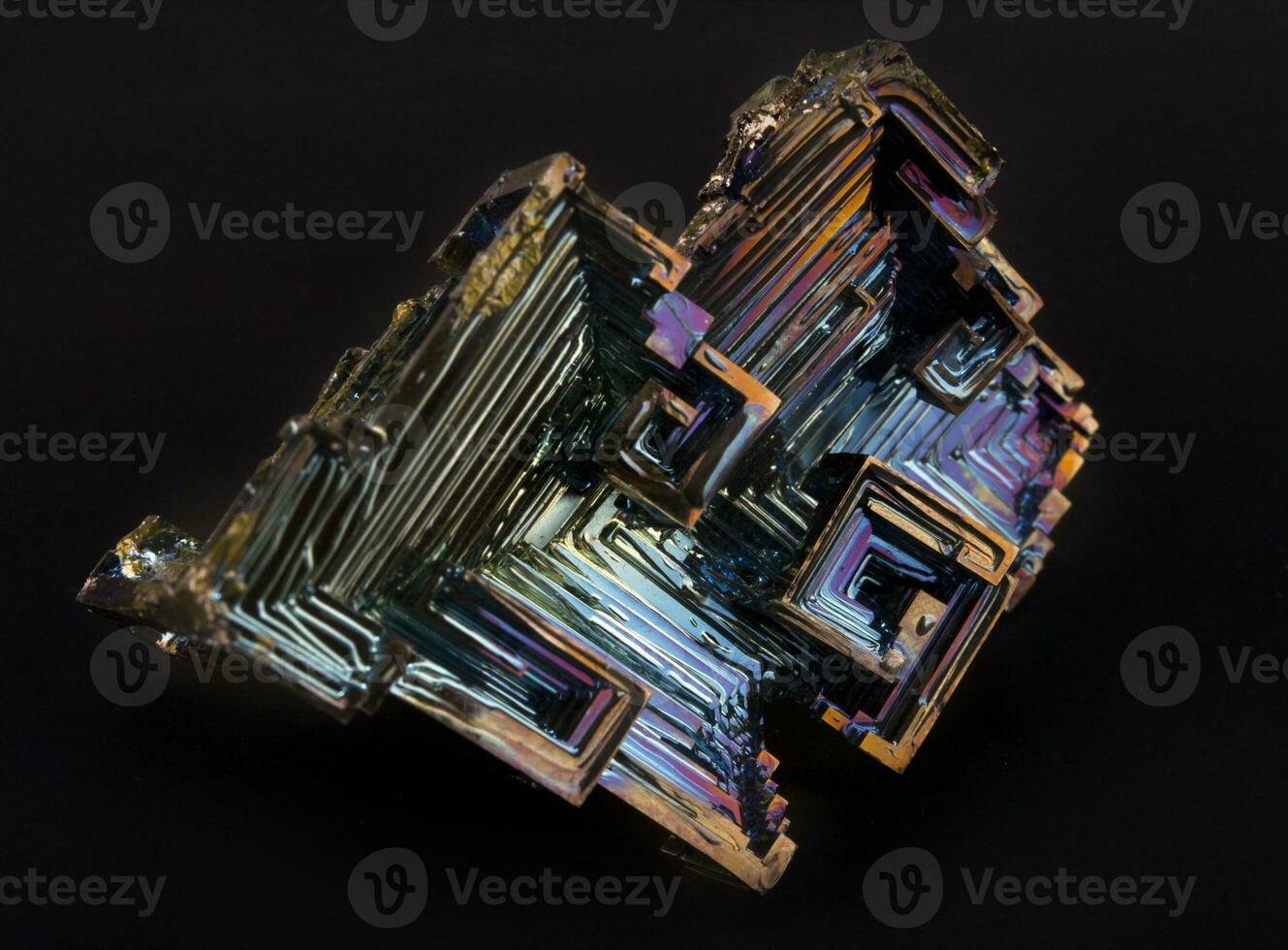 Rainbow colorful mineral bismuth closeup macro on a dark background photo