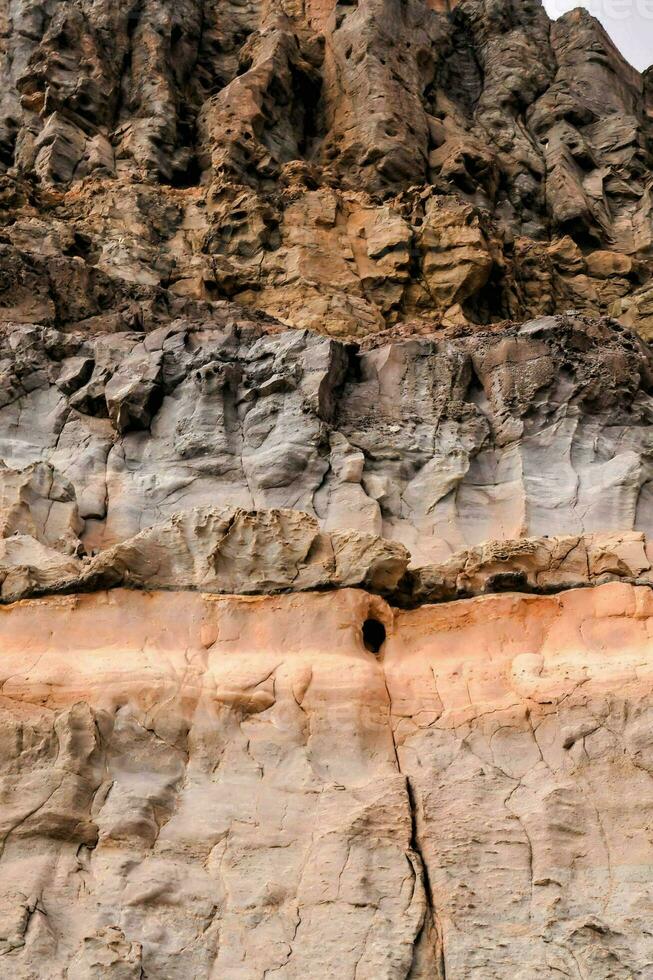 a rock face with orange and brown colors photo