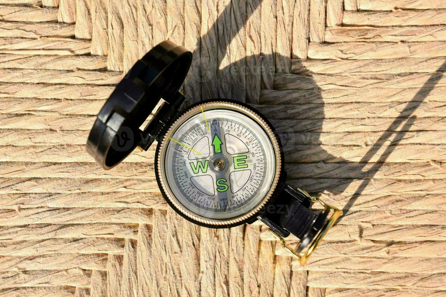 a compass on a woven surface photo