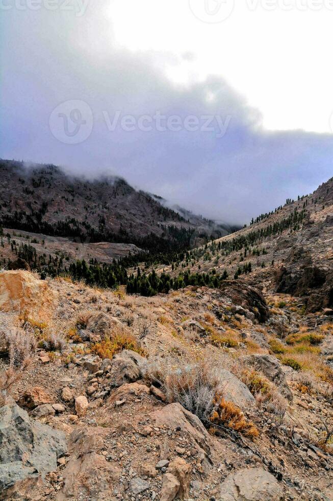 a view of the mountains and clouds from the trail photo