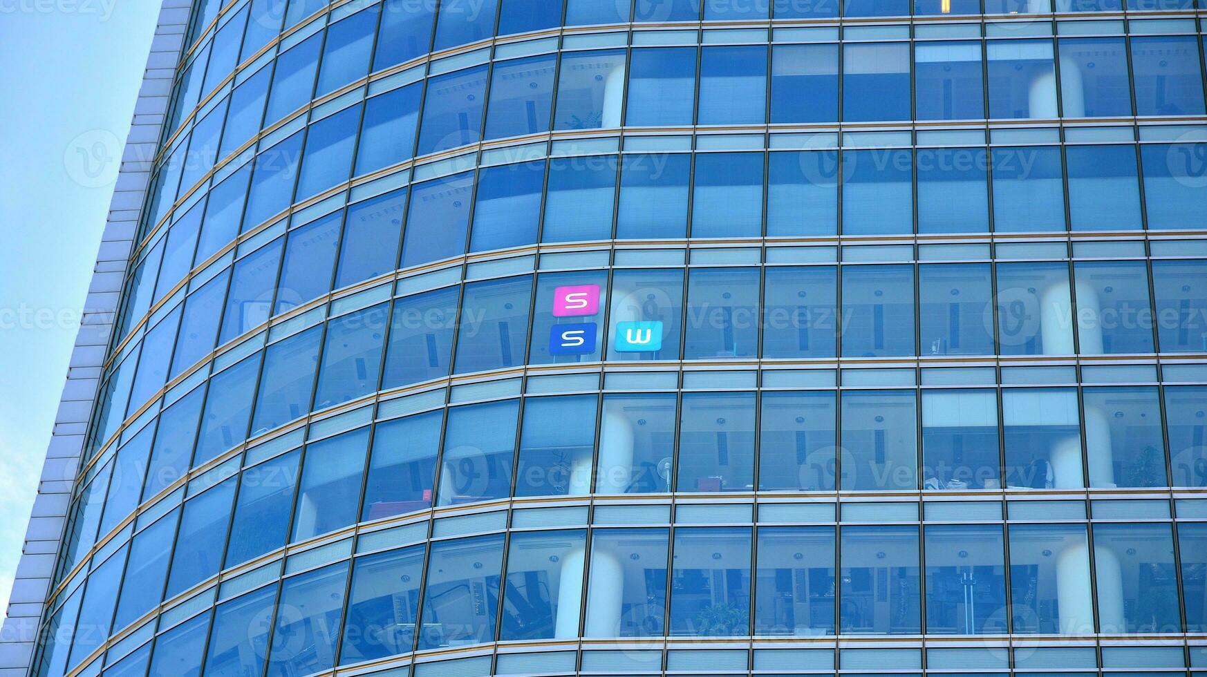 Glass facade of the buildings with a blue sky. Skyscrapers in the business city center.. Background of modern glass buildings. photo