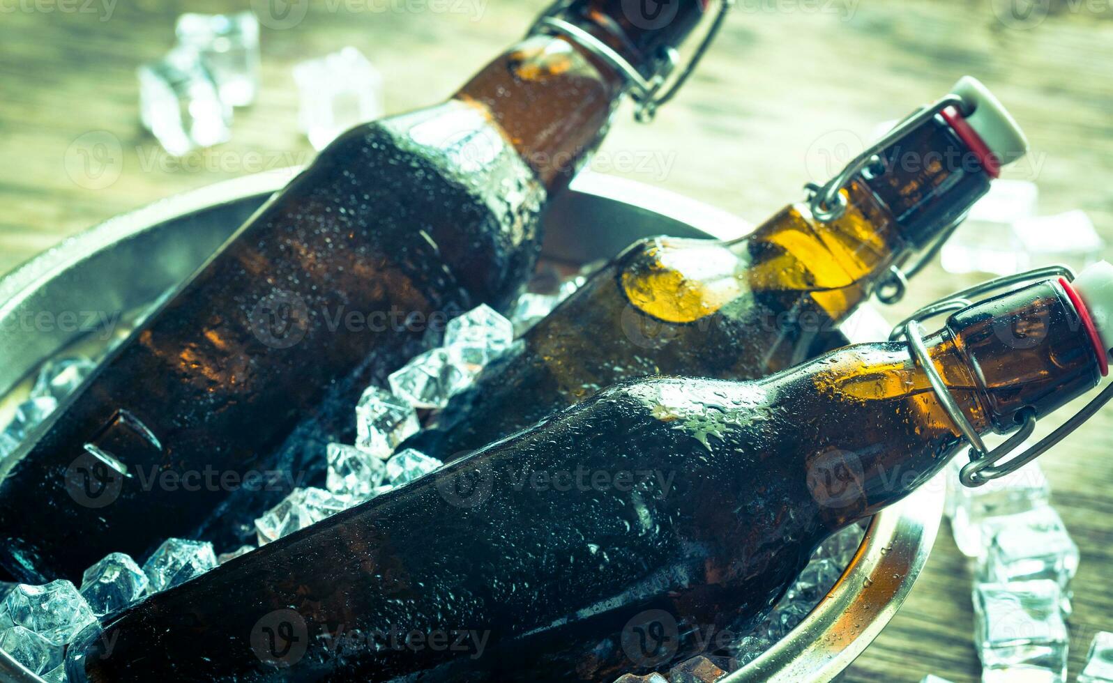Bottles of beer in ice cubes photo