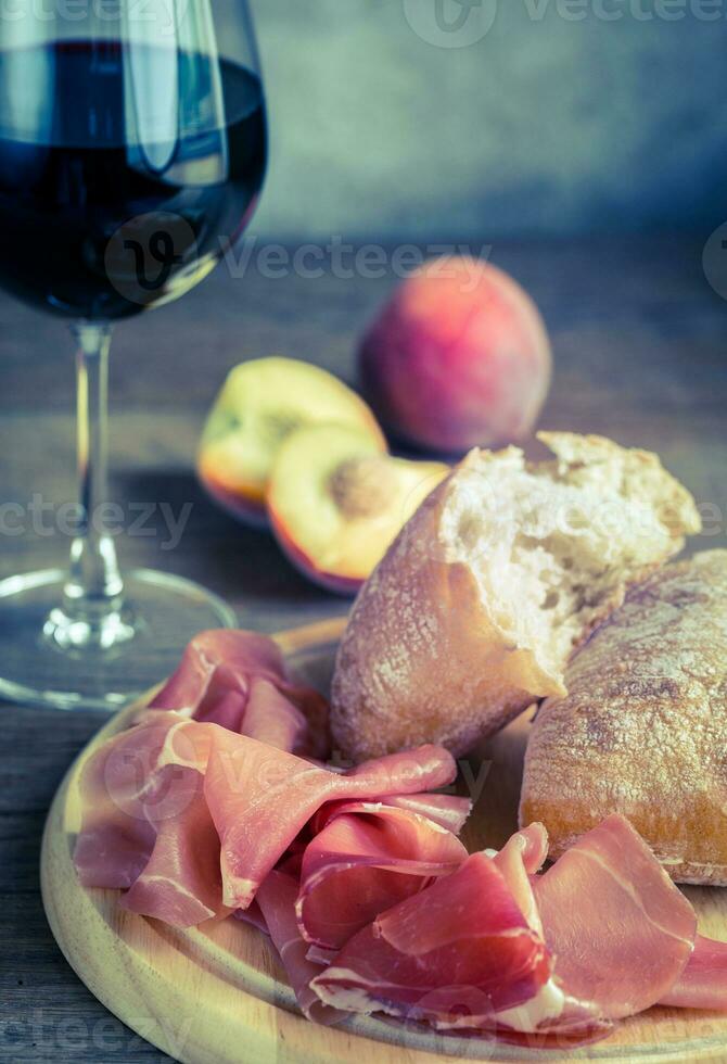 Red wine with prosciutto and ciabatta photo