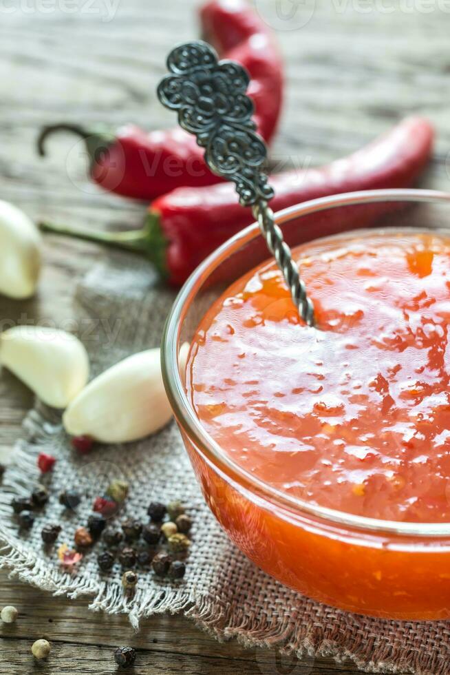 Glass bowl of thai sweet chili sauce photo