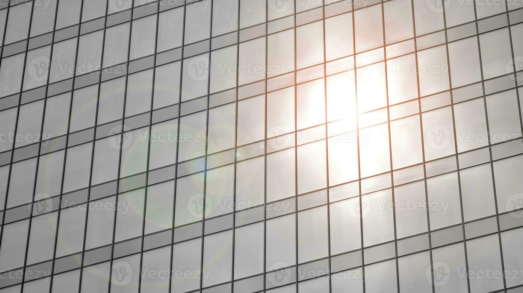 Glass modern building with blue sky background. View and architecture details. Urban abstract - windows of glass office building in  sunlight day. Black and white. photo