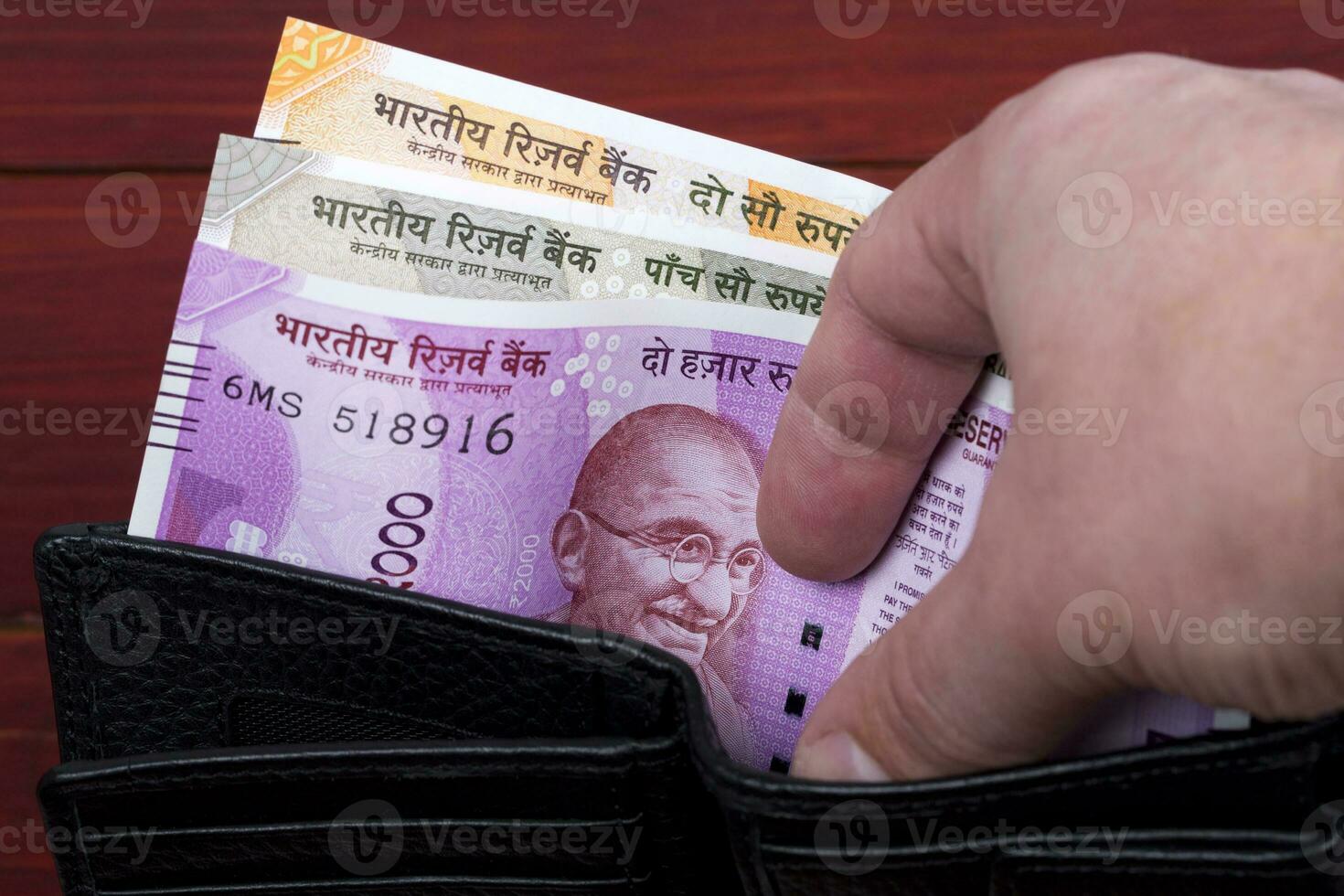 Indian money in the black wallet photo