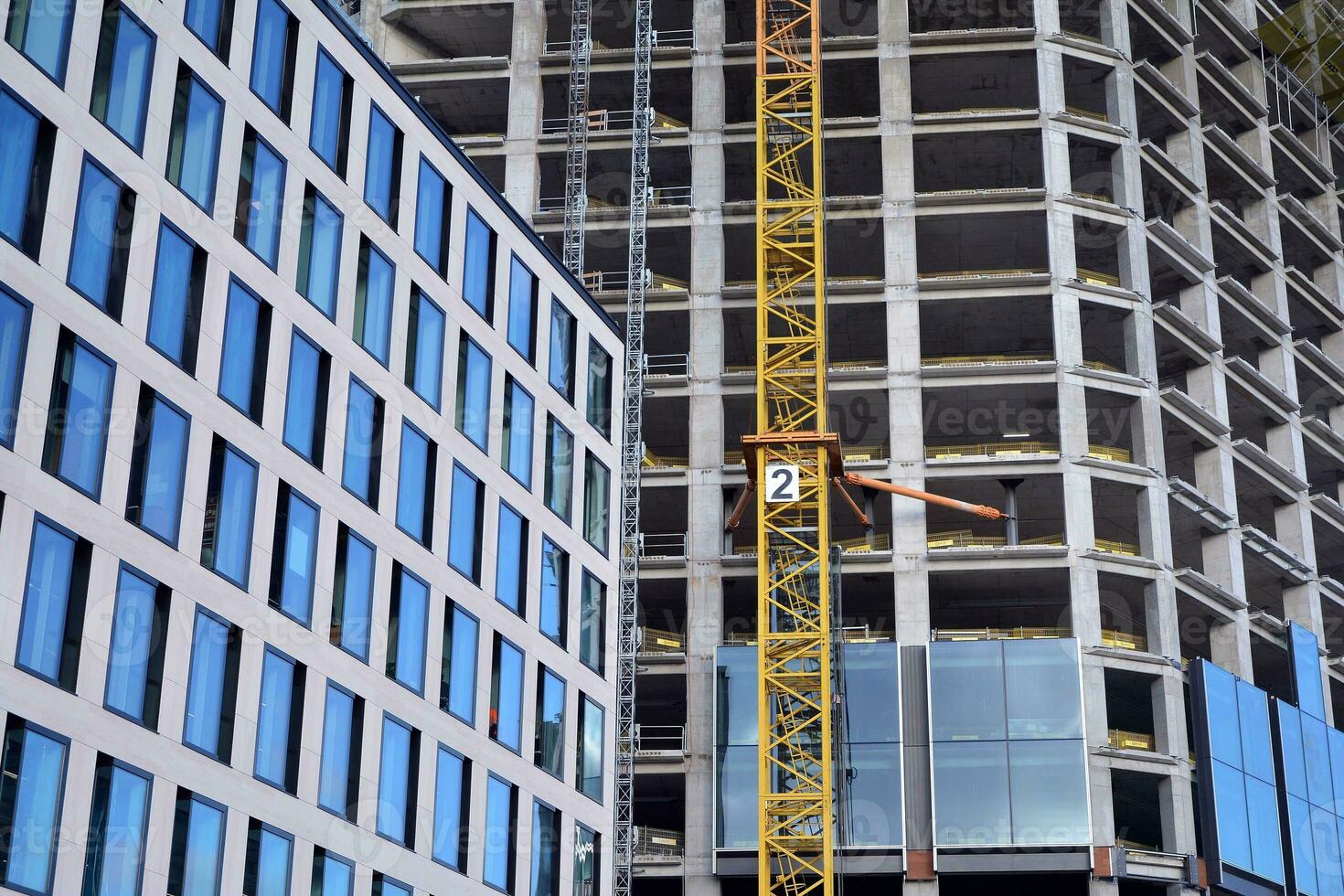 View of a skyscraper under construction. Modern architecture background. Building a high-rise building,  the concept of real estate construction. photo